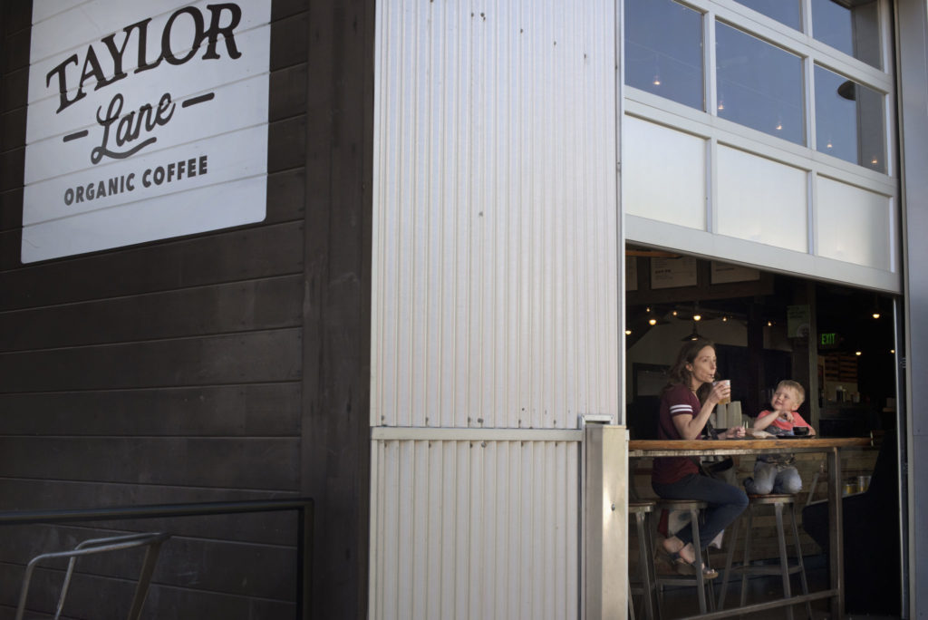 Mary Haynes with her son Lachlan Haynes, 4, enjoying drinks at Taylor Lane Organic Coffee during The Barlow Block Party which benefits businesses affected by recent flooding held Saturday in Sebastopol, California. May 11, 2019. (Photo: Erik Castro/for The Press Democrat)