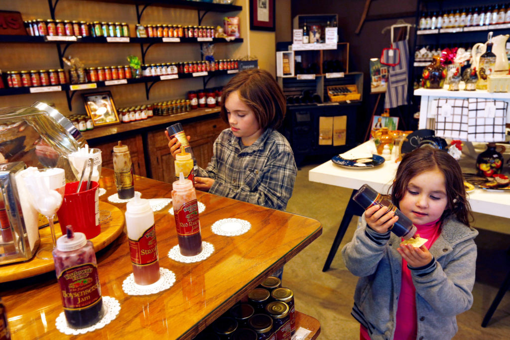 Alisia Gutierrez, 6, right, and her brother Antonio, 9, sample jams and jellies at the Kozlowski Farms store in Forestville, California on Thursday, February 23, 2017. (Alvin Jornada / The Press Democrat)