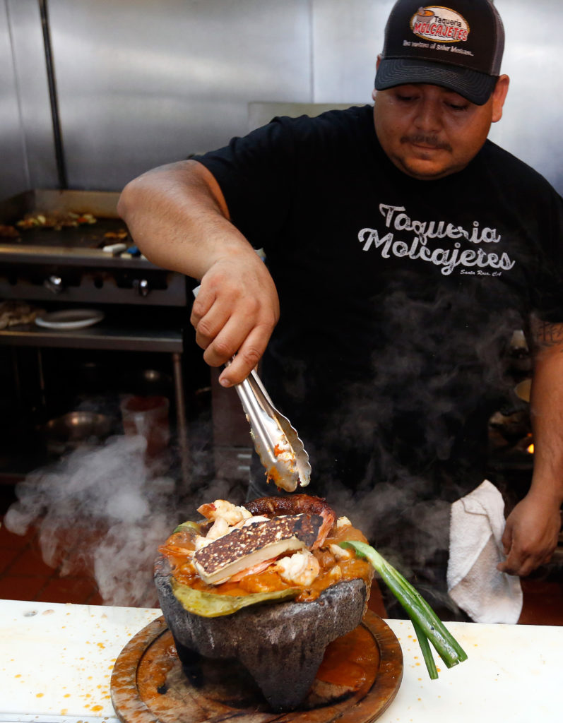 Ismael Gutierrez prepares a molcajete mixto at Taqueria Molcajetes, in Santa Rosa, California, on Wednesday, April 25, 2018. (Alvin Jornada / The Press Democrat)
