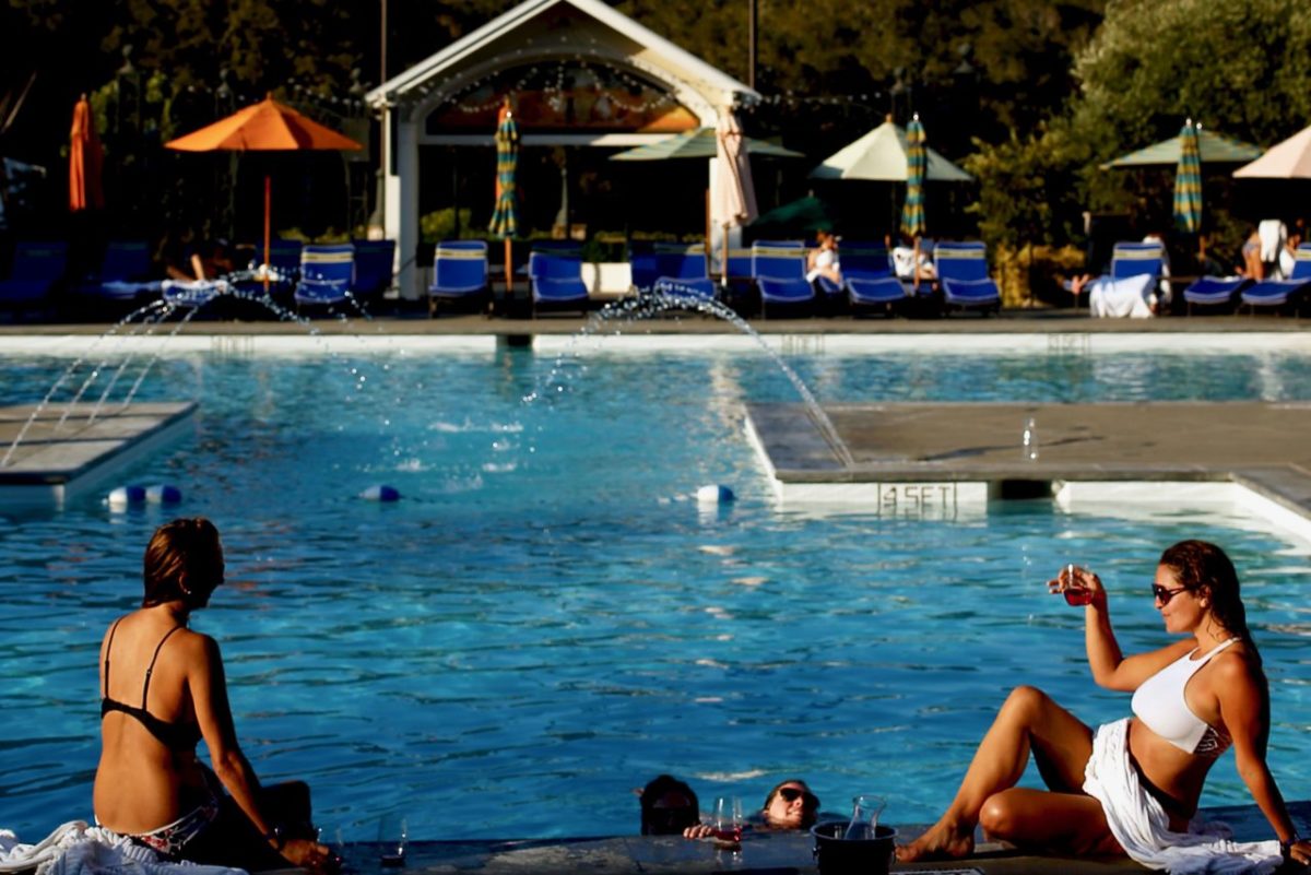 A group of friends lounge poolside with glasses of wine at Francis Ford Coppola Winery in Geyserville, California on Saturday, September 3, 2016. (Alvin Jornada / The Press Democrat)