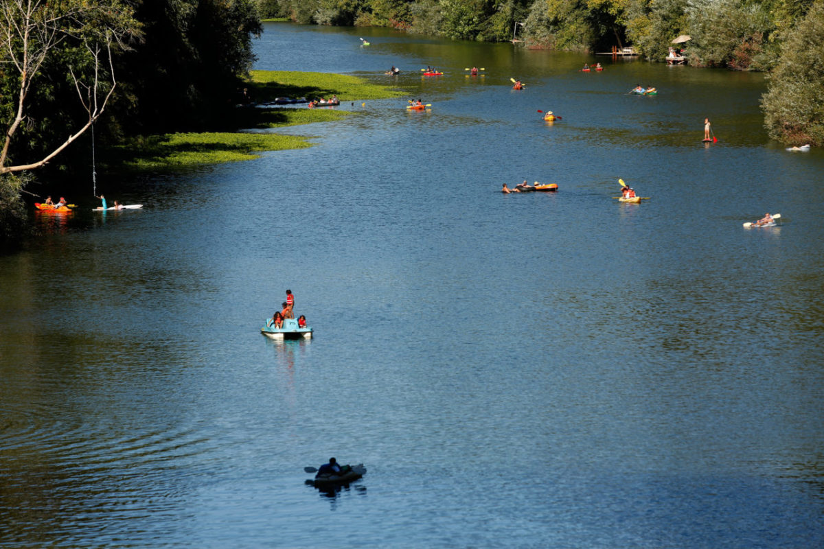 People float down the Russian River by various methods of transport towards Johnson's Beach in Guerneville, California on Sunday, September 6, 2015. (Alvin Jornada / The Press Democrat)