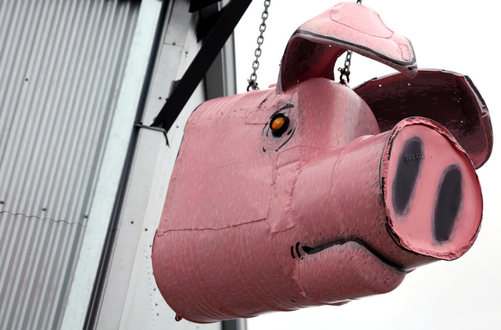 A large pig sculpture by Sebastopol artist Patrick Amiot hangs above Zazu Kitchen and Farm, at The Barlow in Sebastopol. (Christopher Chung/ The Press Democrat)