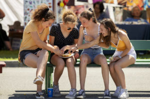 From left, friends Sydney Manka, Ruby Paschoal, Ava Staub and Sydney Doyle dig into a funnel cake on the opening day of the 80th annual Sonoma-Marin Fair in Petaluma. (photo by John Burgess/The Press Democrat)