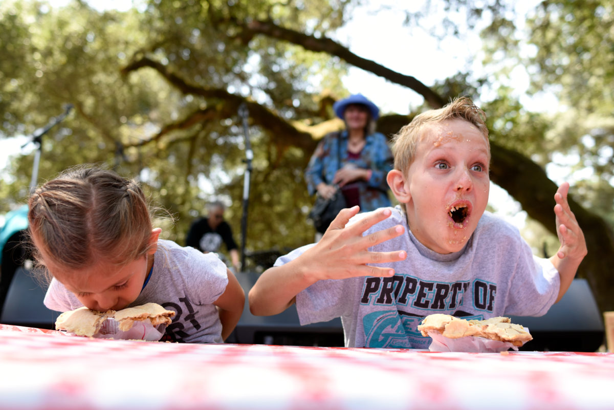 Dylan Gloeckner, age 10, right, reacts to the temperature of his apple pie as he competes in the pie eating contest with his cousin Olivia Padron, age 3, left, at the Gravenstein Apple Fair in Sebastopol, California, on Aug. 8, 2015. (Alvin Jornada / The Press Democrat)