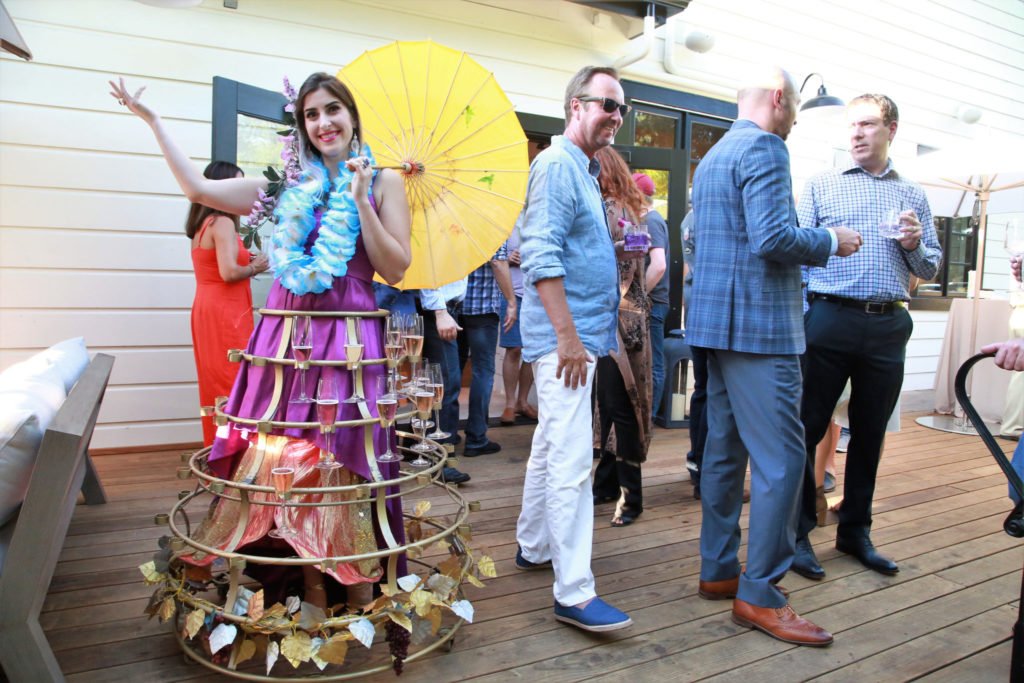 Josselyn Maquette, offers sparkling wine to guests at the Grand Reopening of MacArthur Place in Sonoma California, Thursday August 1, 2019. (Photo Will Bucquoy/For Sonoma Magazine).