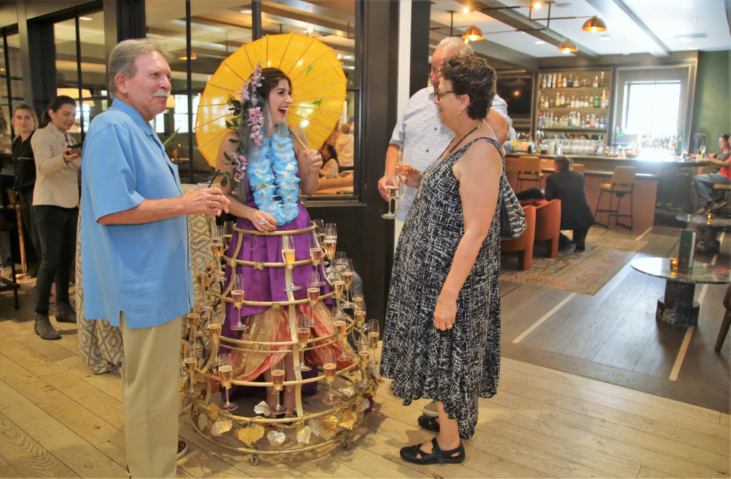Josselyn Maquette, offers sparkling wine to guests arriving at the Grand Reopening of MacArthur Place in Sonoma California, Thursday August 1, 2019. (Photo Will Bucquoy/For Sonoma Magazine).