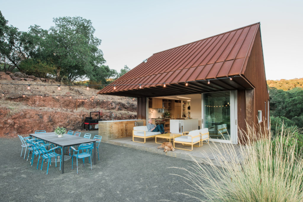 The home is perched on a steep hill and from the back of the house looks like a small structure.