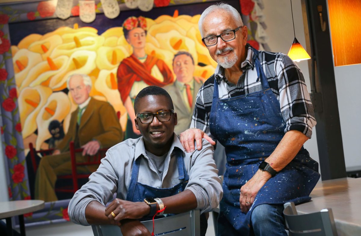 Artist Mario Uribe, right, and Mamadou Diouf own and operate Cafe Frida Gallery in the South of A Street arts district in Santa Rosa.(Christopher Chung/The Press Democrat)