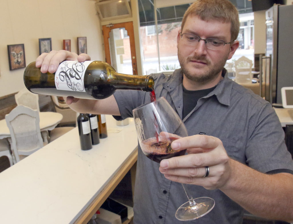 Mike Barber owner Barber Cellars pours a glass of wine in his new wine tasting room on Washington St. in downtown Petaluma on Tuesday, October 27, 2015. (SCOTT MANCHESTER/ARGUS-COURIER STAFF)