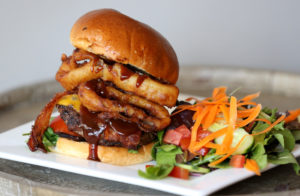 The Western Burger featuring onion rings, cheddar cheese, applewood bacon, and barbecue sauce at the new Carmen's Burger Bar location at 619 4th St in Santa Rosa on Wednesday, August 21, 2019. (BETH SCHLANKER/ The Press Democrat)