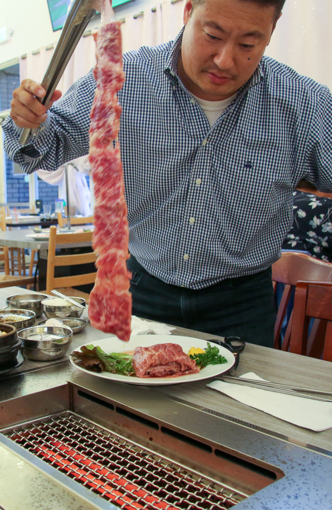 Han Soh demonstrates barbecue cooking at Han Bul Korean BBQ in Santa Rosa. (Heather Irwin/The Press Democrat)