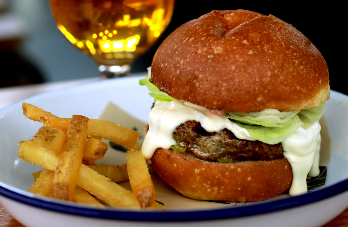 The Handline "Inglewood" burger features pastured beef, St. Jorge fonduta, iceberg lettuce, spicy pickle relish and thousand island on a toasted bun. (John Burgess / The Press Democrat)