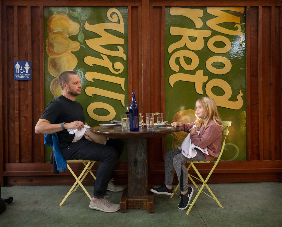 Locals Vegar Svanemyr and his son Isa, 6, walked a few blocks to enjoy their dinner at the Willow Wood Market Cafe in Graton. (John Burgess/The Press Democrat)