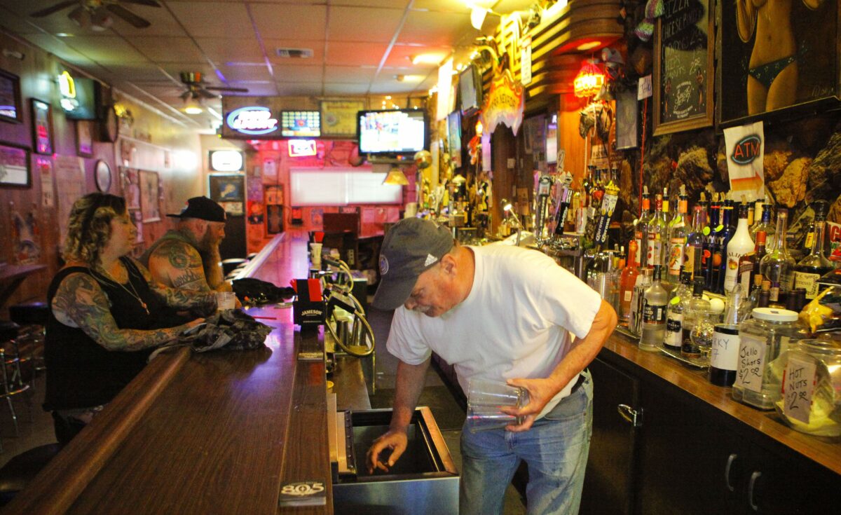 Petaluma, CA, USA. Monday, July 17, 2017._ Bartender Bruce Rowe serves drinks at Gale's Central Club in downtown Petaluma while Yuri Andrea Hill of Guernville enjoy cold beers. (CRISSY PASCUAL/ARGUS-COURIER STAFF)