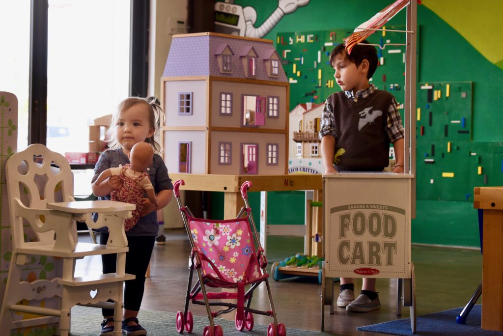Evelyn Sevilla, 18-months, of Glen Ellen plays with a doll while Niko Arnold, 5, of Santa Rosa strolls around with a food cart in an imagination play area called the "Wonderground" at Fundemonium toy and hobby store in Rhonert Park, California. April 14, 2019. (Photo: Erik Castro/for The Press Democrat)