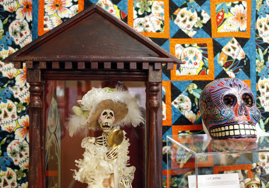The piece "La Catrina Admires her Gold Tooth", left, by artist Dan Scannell is on display at the Windsor Arts Council Gallery for the D’a de los Muertos or Day of the Dead celebration in Windsor, California on Sunday, October 9, 2011. (BETH SCHLANKER/ The Press Democrat)