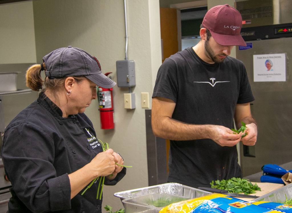 Chef Heather Ames and Chef Gabe Velasquez of KJ Wine Estates and Gardens prepare the parsley. Heather Irwin/PD