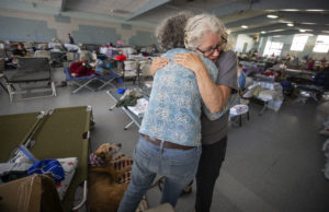 Red Cross volunteer Barbara Wood gives a hug to a Kincade fire evacuee who seemed in distress at the Red Cross Shelter at the Sonoma County Fairgrounds on Sunday, October 27, 2019. (John Burgess/The Press Democrat)
