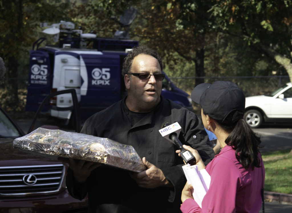 Chef Ken Rochioli gets interviewed by a reporter at the Healdsburg Community Center. Heather Irwin/PD