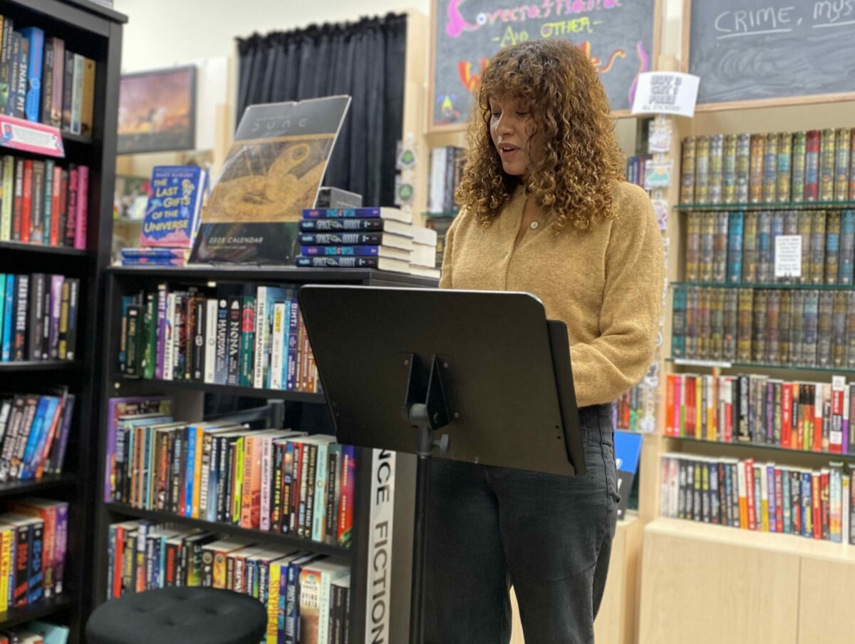 Eirinie Carson reading one of the winning stories in the Argus-Courier's annual Scary Story Competition, on Sunday, Oct. 27, 2024, at the Word Horde Emporium of the Weird and Fantastic in Petaluma. (Ross Lockhart)