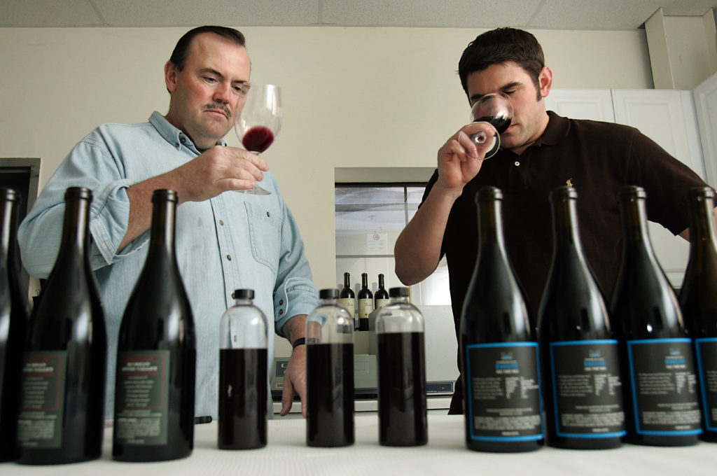3/15/2009:D1: Palmer and Mauritson taste pinot blends at the Mauritson Winery in the Dry Creek Valley. Palmer, who lives in Healdsburg, built a house there and planted his own 2-acre pinot noir vineyard. PC: Restauranteur Charlie Palmer, left, tastes pinot blends with Clay Mauritson, the winemaker teaming up with Palmer, at the Mauritson Winery in the Dry Creek Valley.