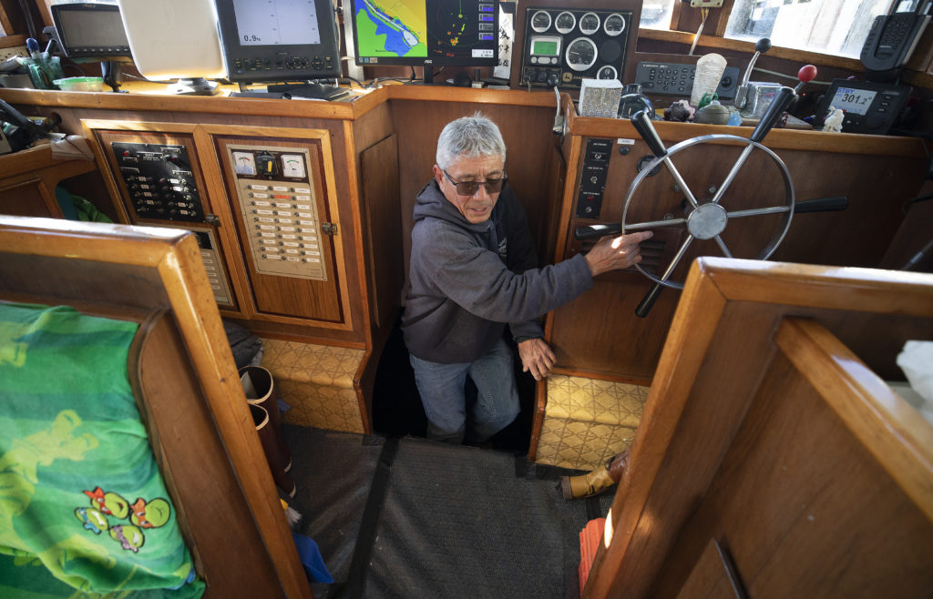Dick Ogg crawls out of the engine room on the Karen Jeanne at the Spud Point Marina in Bodega Bay. (John Burgess)