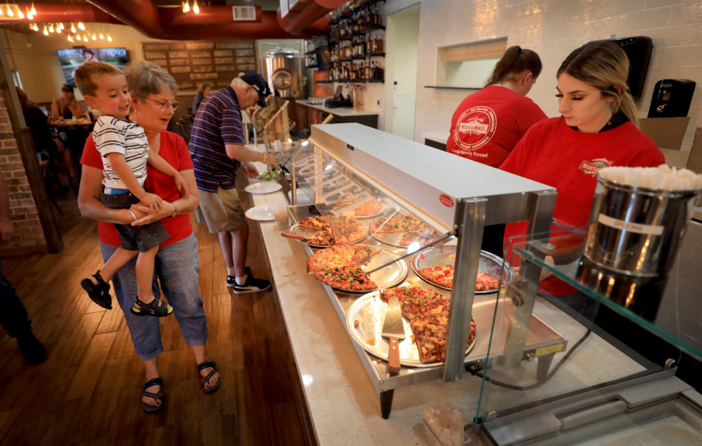 Diantha Okrepkie and her grandson Tillman Okrepkie, 3, look over the pizza buffet at the newly reopened Mountain Mike's Pizza, Friday, July 5, 2019. The 2017 Tubbs fire destroyed their original location. (Kent Porter / The Press Democrat) 2019