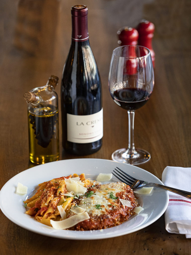 Pollo Parmigiana, oven baked chicken breast layered with mozzarella with a side of marinara penne from Trattoria Roma in the Petaluma Theater District. (John Burgess)
