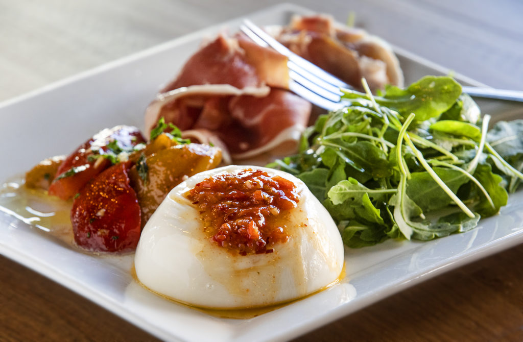 Mozzarella burrata, prosciutto, arugula and roasted red pepper oil from Trattoria Roma in the Petaluma Theater District. (photo by John Burgess/The Press Democrat)