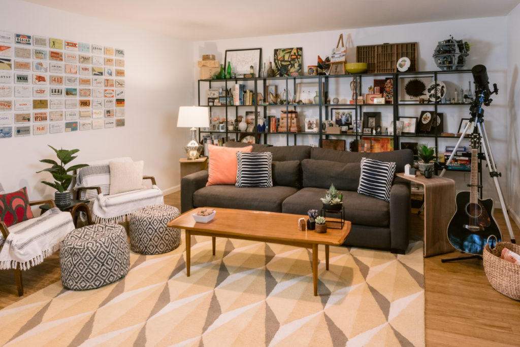 Family room displaying vintage call cards and shelf in background with collected trinkets.