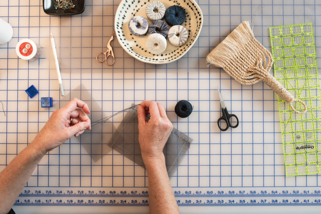 Kathryn uses precise measurements to accurately depict the maps that she uses as a basis for her fiber art pieces.
