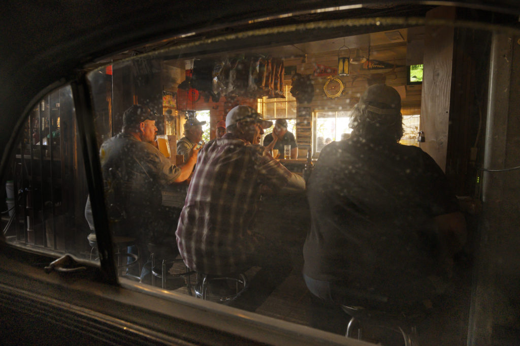 The bar seen through the passenger window of a 1947 Chrysler Windsor which is parked on the back side of the bar at ErnieÕs Tin Bar on Lakeville Highway in Petaluma, California. November 22, 2019. (Photo: Erik Castro/for Sonoma Magazine)