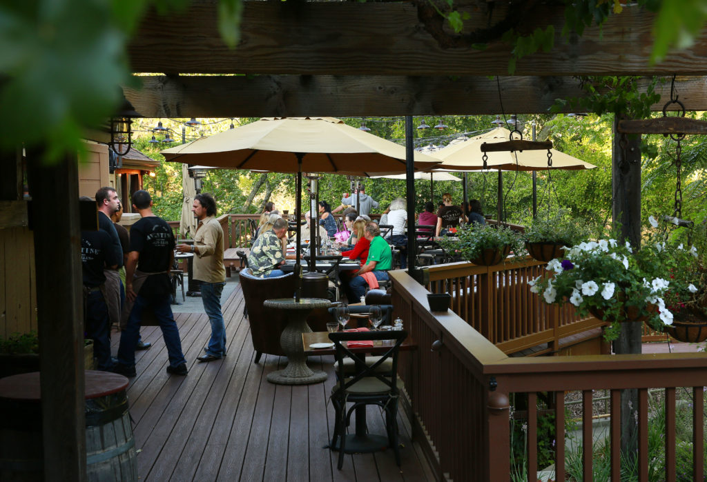 The outside dining area gets ready for the dinner crowd at Aventine Glen Ellen on Wednesday, August 20, 2014. (Conner Jay/The Press Democrat)