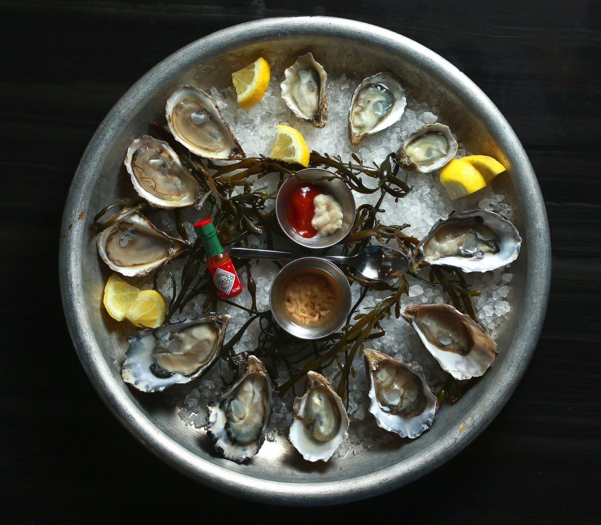 The Dozen Oysters plate at The Shuckery in Petaluma includes St. Simone, Kumamoto and Hog Island oysters. (John Burgess / The Press Democrat)