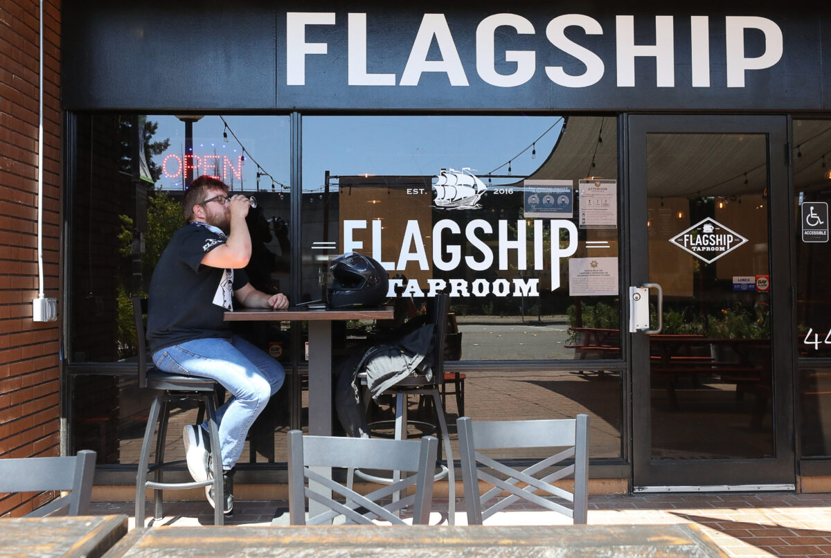 Brandon Stevens drinks a beer on the patio of Flagship Taproom in Santa Rosa on Monday, July 13, 2020. The taproom closed its indoor seating area Monday due to reinstated coronavirus restrictions. (Christopher Chung/ The Press Democrat)