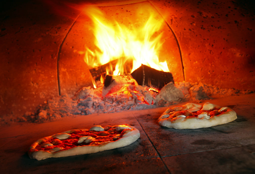 9/26/2012: D1: PC: Marguerita pizza cooks in the wood fire oven at VJB Vineyards and Cellars in Kenwood.