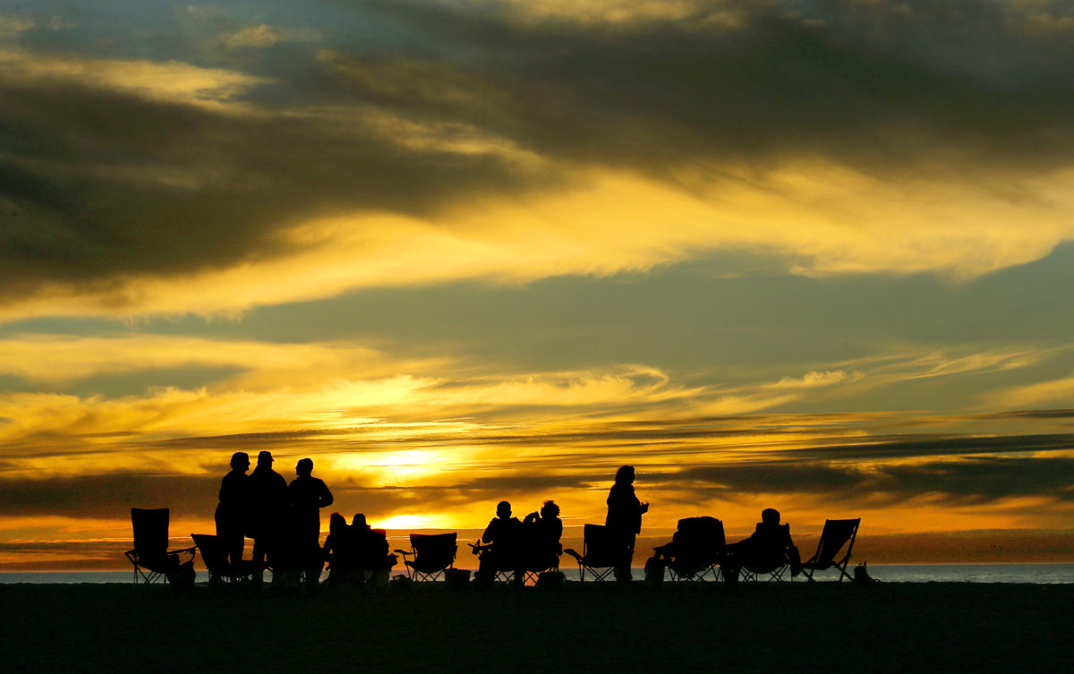 When a group of friends discovered they didn't have a sunset view from their campsite, they move their chairs onto the beach at Wright's Beach Campground on the Sonoma Coast. (JOHN BURGESS / The Press Democrat)