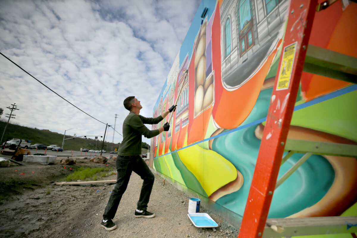 Mural artist Maxfield Bala works on his "Welcome to Petaluma" mural project on Petaluma Blvd South along Highway 101 in Petaluma on Monday, January 28, 2019. (Beth Schlanker / The Press Democrat)