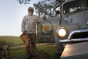 John McGinnis, who runs the beekeeping business Buzz Off Honey, at his home at Goah Way Ranch in Petaluma. (Erik Castro)