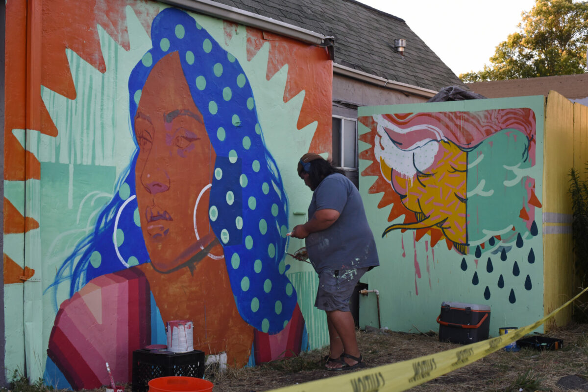 Mural festival co-founder Joshua Lawyer working on his mural located on the side of a women’s clothing store on Sebastopol Road during The Mural Festival in Roseland neighborhood of Santa Rosa on Tuesday, June 28, 2022. (Erik Castro / For The Press Democrat)