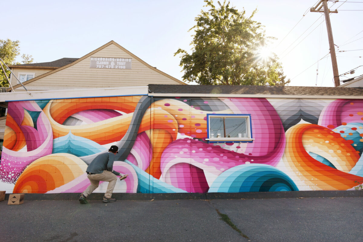 Ricky Watts, a Sebastopol-based artist, working on the final touches of his mural on Tia Maria Panaderia y Pasteleria on Sebastopol Road during The Mural Festival in Roseland neighborhood of Santa Rosa on Monday, June 27, 2022. (Erik Castro / For The Press Democrat)