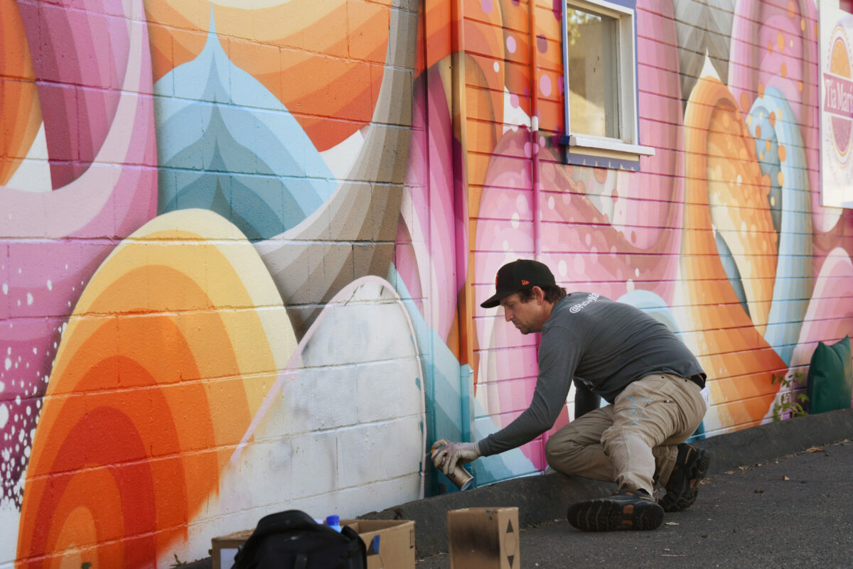 Ricky Watts, a Sebastopol-based artist, working on the final touches of his mural on Tia Maria Panaderia y Pasteleria on Sebastopol Road during The Mural Festival in Roseland neighborhood of Santa Rosa on Monday, June 27, 2022. (Erik Castro / For The Press Democrat)