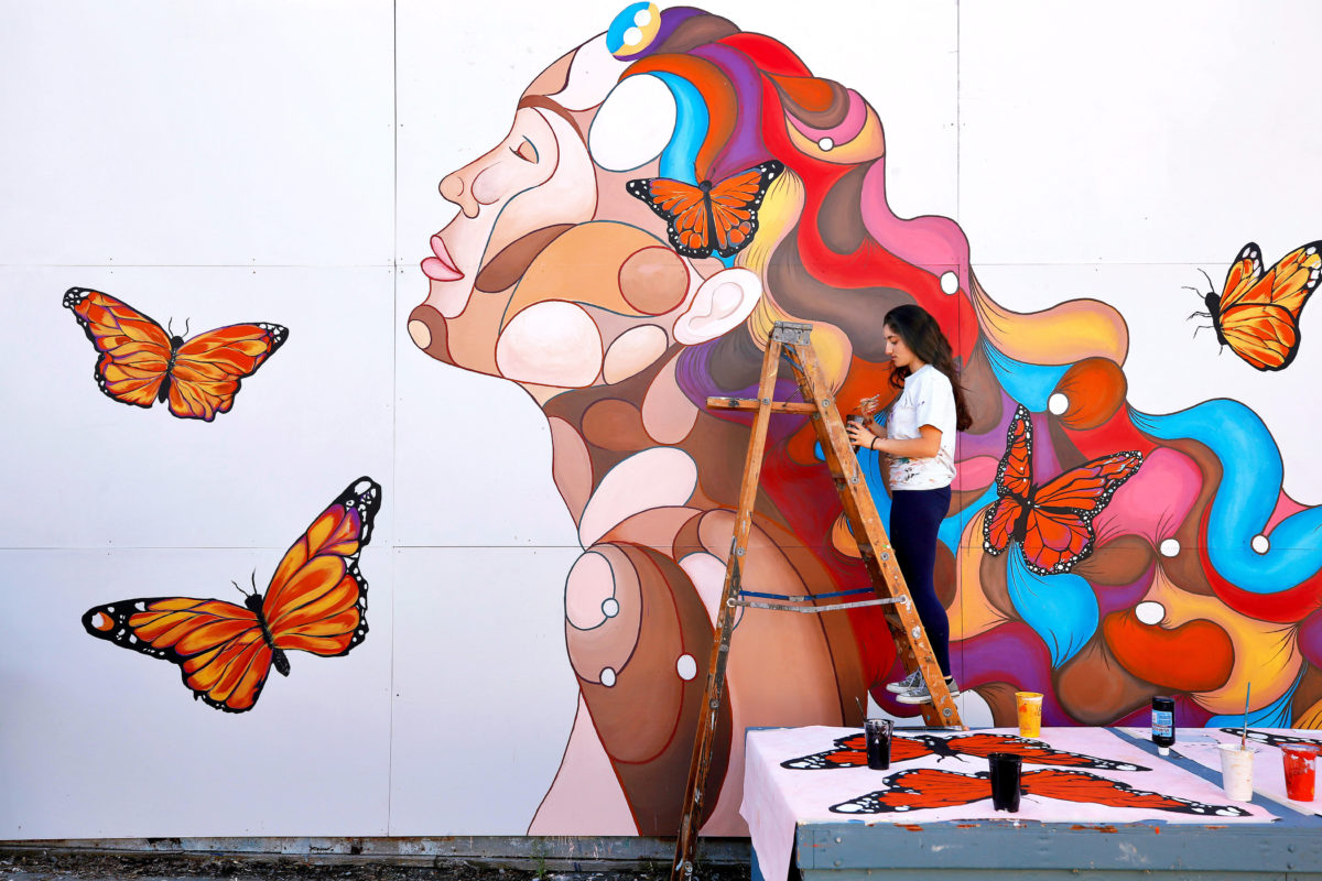 Montgomery High School junior Rima Makaryan, 16, paints details on the "Dreamer" mural she created at Montgomery High School in Santa Rosa, on Saturday, March 30, 2019. (Alvin Jornada / The Press Democrat)