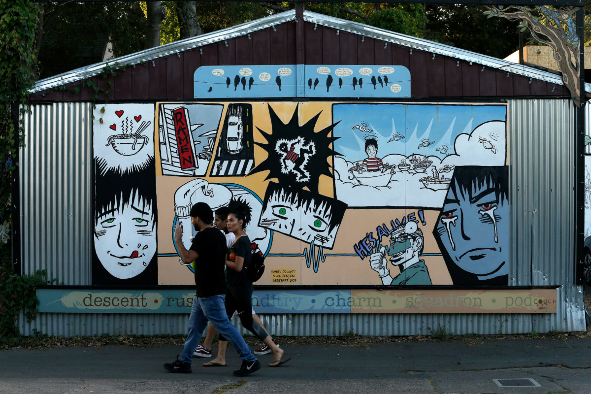 Pedestrians walk past a mural created by Daniel Doughty and Nick Jensen at Art Alley in the SOFA arts district of Santa Rosa, California, on Friday, May 3, 2019. (Alvin Jornada / The Press Democrat)