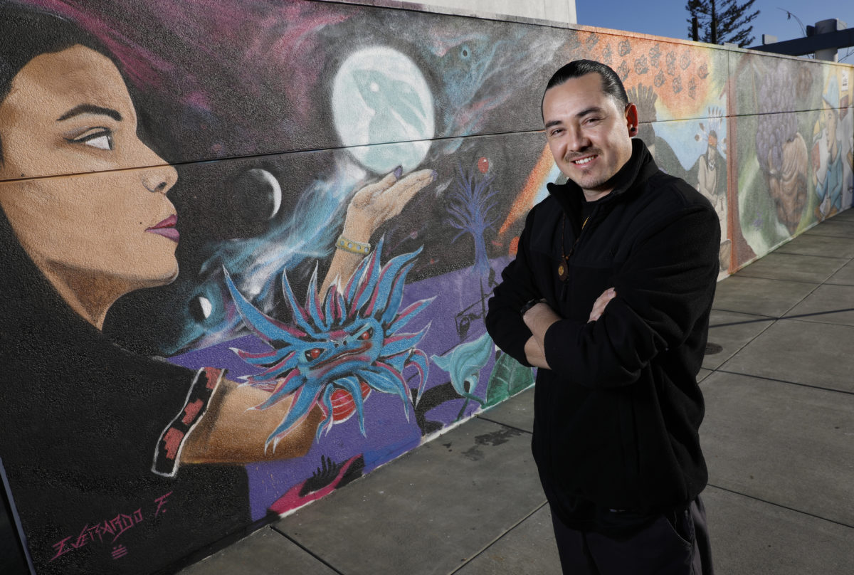 Emmanuel Morales is one of three artists that helped to create a mural celebrating diversity, native culture, and the immigrant experience on a wall which had been previously vandalized with pro-Trump sentiments. Photo taken at Cali Calmecac Language Academy on Friday, January 13, 2017, in Windsor. (Beth Schlanker/The Press Democrat)