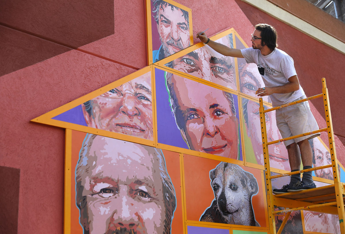 Artist Daniel Doughty touches up parts of the Palms Inn Project, in Santa Rosa on Tuesday, September 12, 2017. (Christopher Chung/ The Press Democrat)
