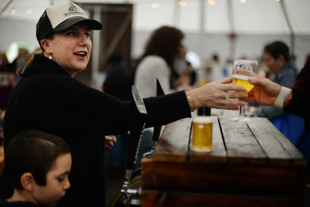 St. Florian's Brewery owner Amy Levin of Windsor with her son Cooper Levin, 7, bottom left, pouring her Session Ale during the 11th annual California Artisan Cheese Festival held at the Sheraton Sonoma County in Petaluma Sunday. March 26, 2017. (Photo: Erik Castro/for The Press Democrat)