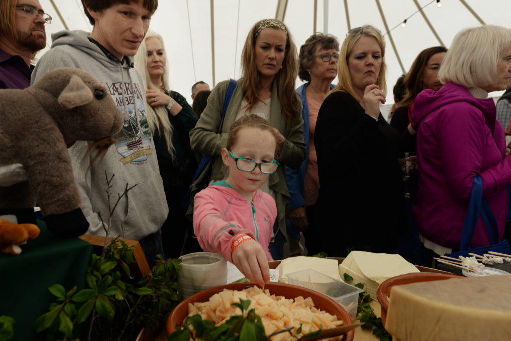 Evelyn Wood, 8, in pink, sampling Boont Corners Reserve, a 10-month aged goat/sheep milk cheese at the Penny Royal Farm booth with her father Scott Wood, left, from Santa Rosa, during the 11th annual California Artisan Cheese Festival held at the Sheraton Sonoma County in Petaluma Sunday. March 26, 2017. (Photo: Erik Castro/for The Press Democrat)