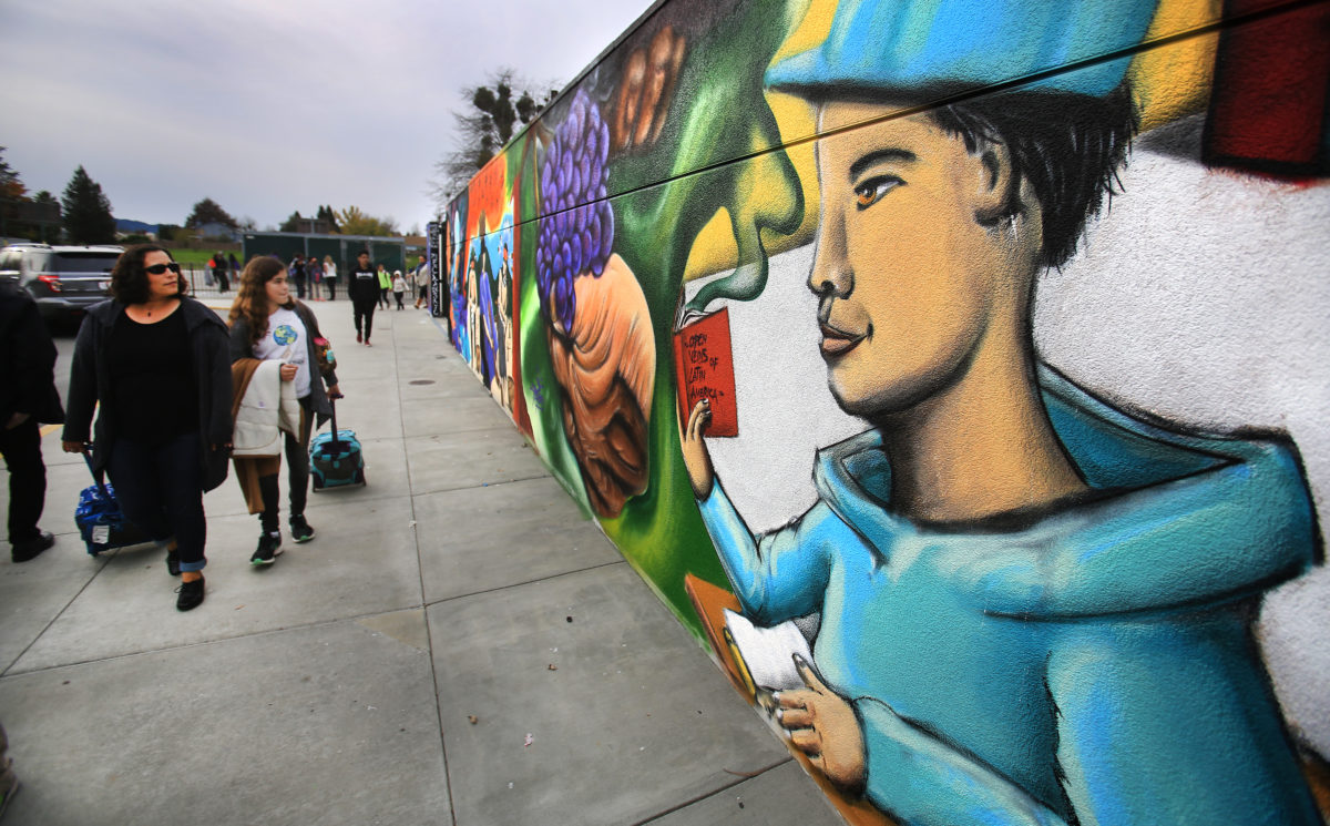 Over the weekend, students from Santa Rosa Junior College painted a mural at the side entrance to Cali Calmecac in Windsor, Monday Dec. 5, 2016 in an area that was spray vandalized with president elect Trump's name and an anti-immigrant message of "build the wall higher". (Kent Porter / The Press Democrat) 2016
