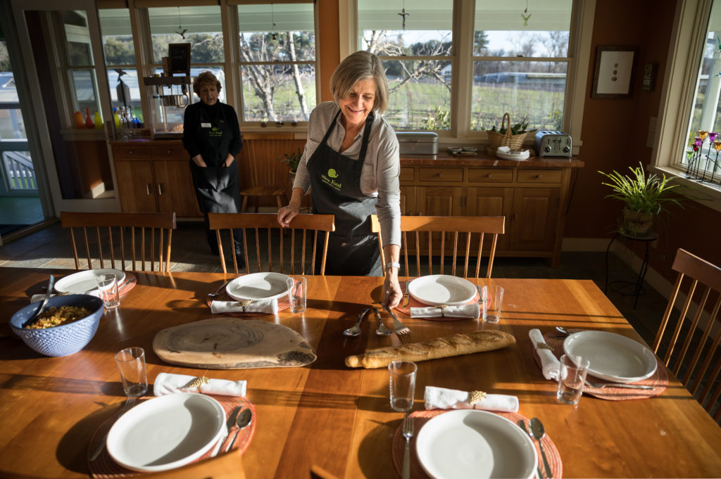 Slow Food story Carol Diaz and the Slow Food group have a dinner at her house Carol Diaz setting the table with Lynn Davis in the background